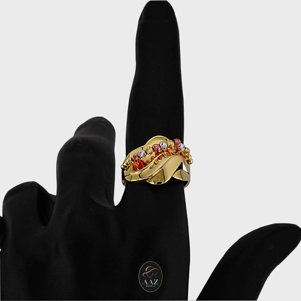 Tri Color Swirl 21K Gold Ring on an index finger