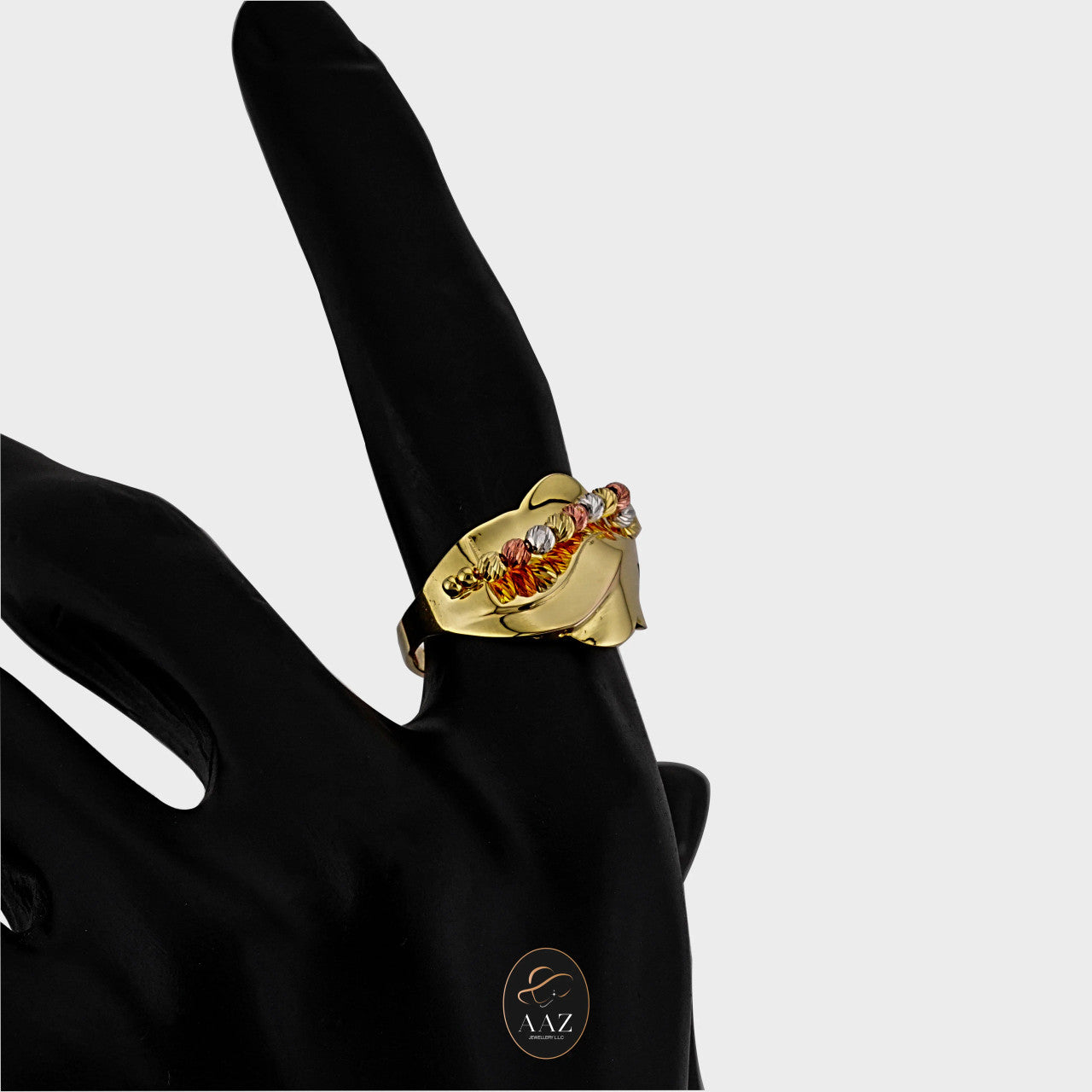 Tri Color Swirl 21K Gold Ring on an index finger
