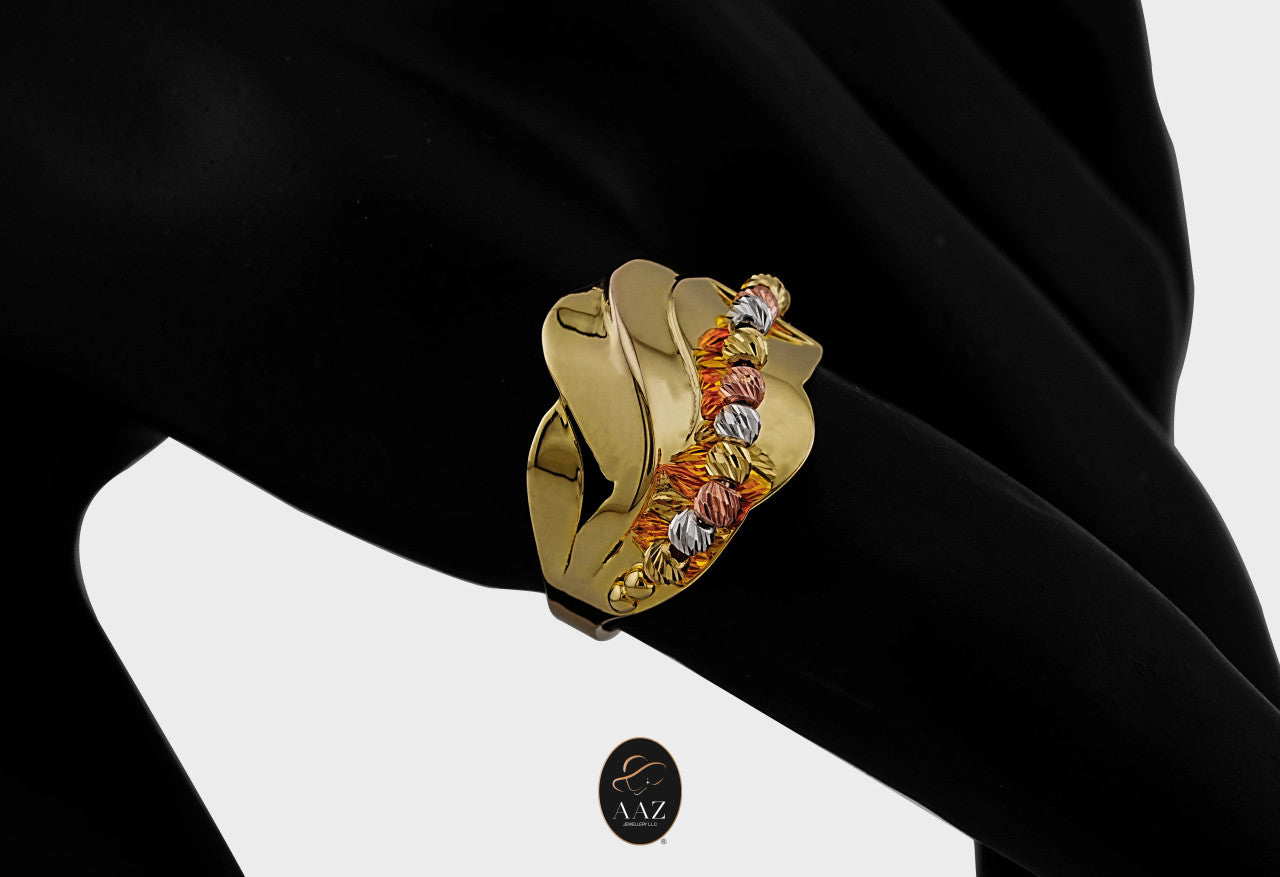 Tri Color Swirl 21K Gold Ring on an index finger