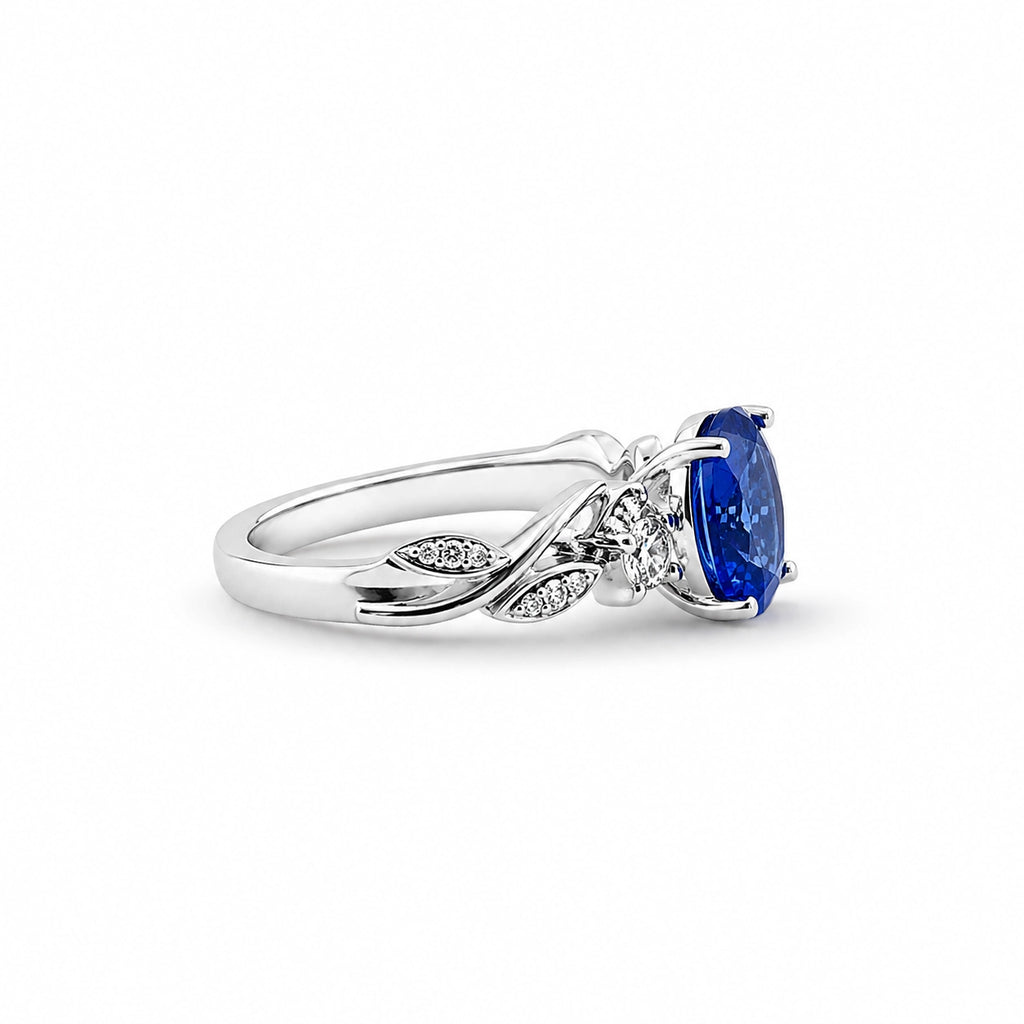 Floral tanzanite ring in 18K white gold, side view of the diamond-set leaves