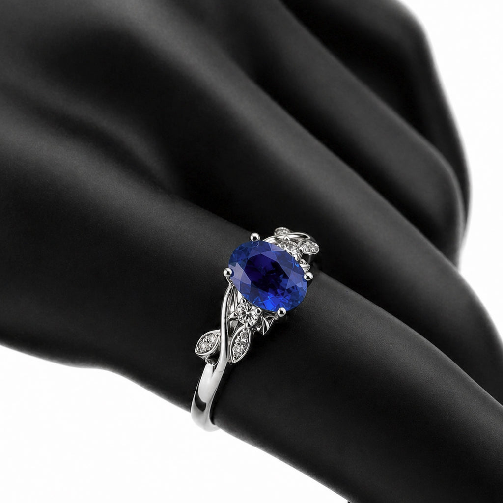 Floral tanzanite ring in 18K white gold shown on a hand